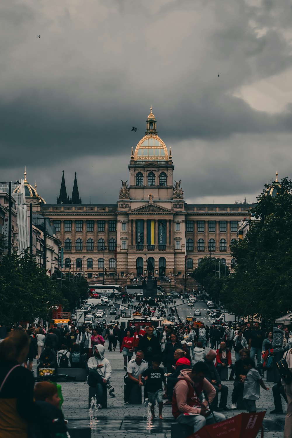 a crowd of people walking around a large building