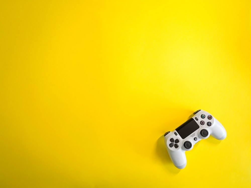 a video game controller on a yellow background