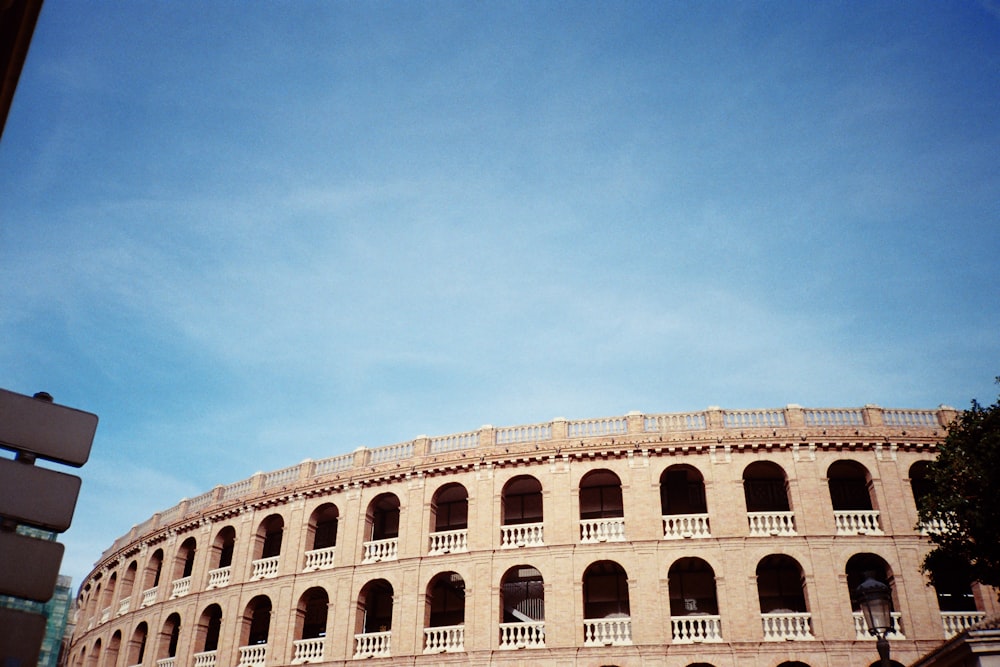 a large brick building with arches and balconies