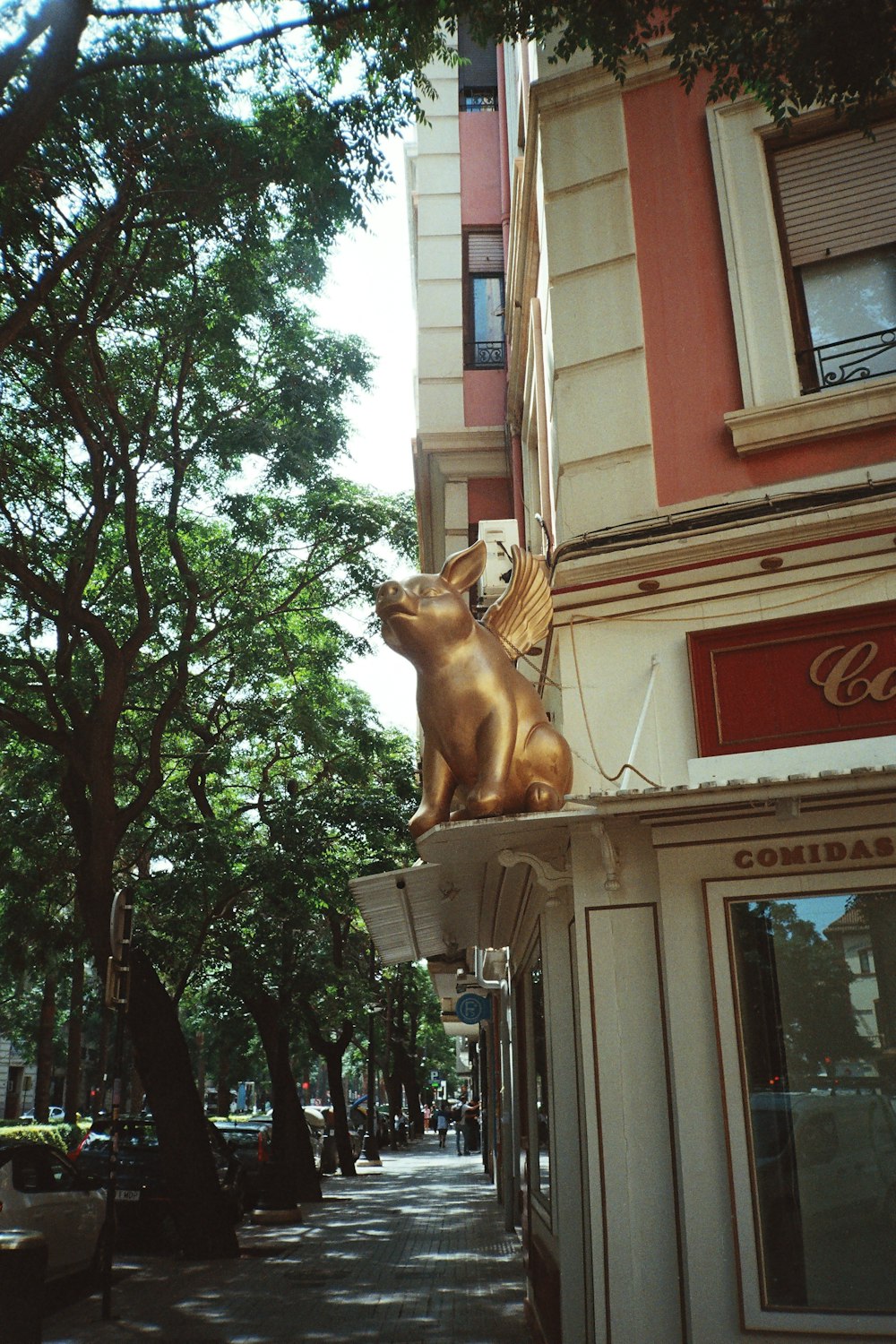 a statue of a dog on top of a building