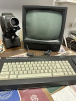 A vintage computer monitor displaying green text on black background in a dark room.