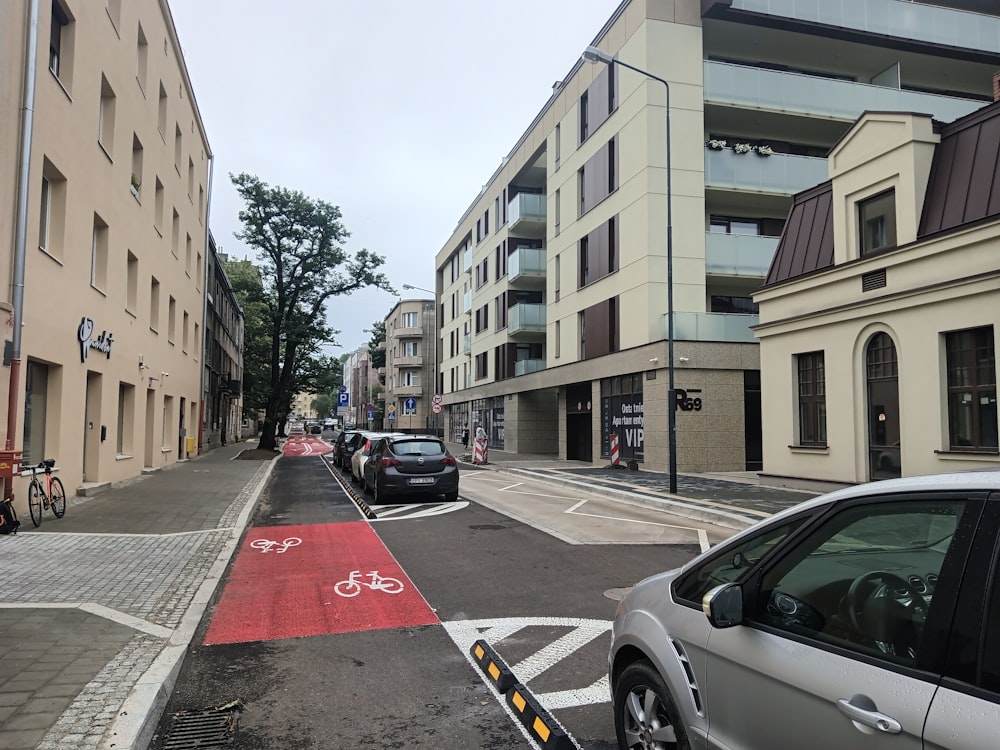 a city street with cars parked on both sides of the street