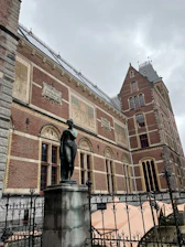 A modern academic building with subtle artistic nude-themed decorations.