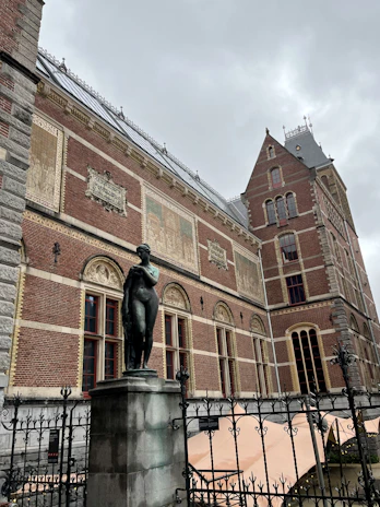 A modern academic building with subtle artistic nude-themed decorations.