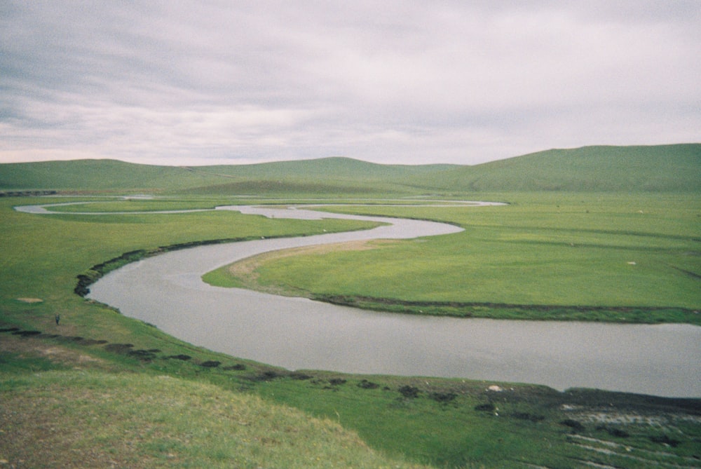 a river running through a lush green countryside