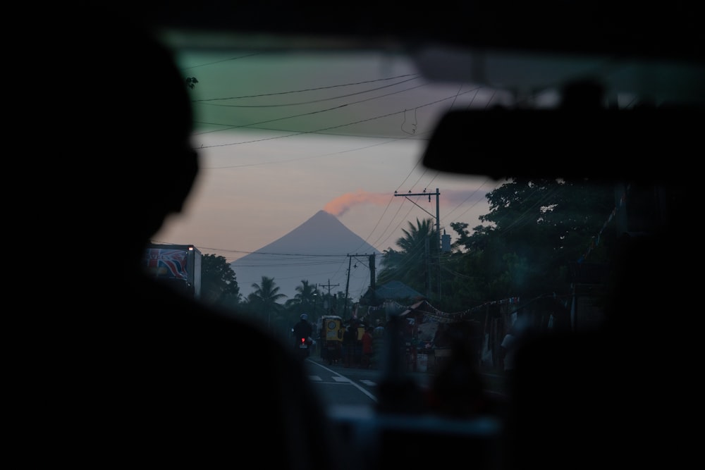 a view of a mountain from inside a vehicle