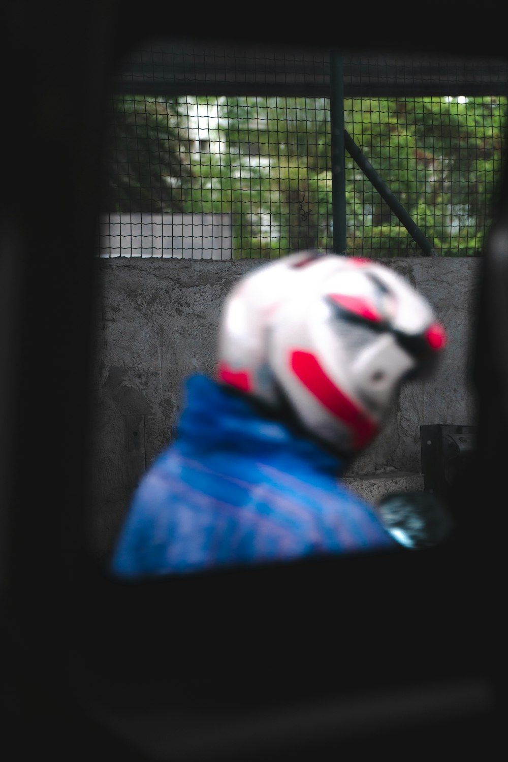 a person wearing a clown mask and a blue jacket