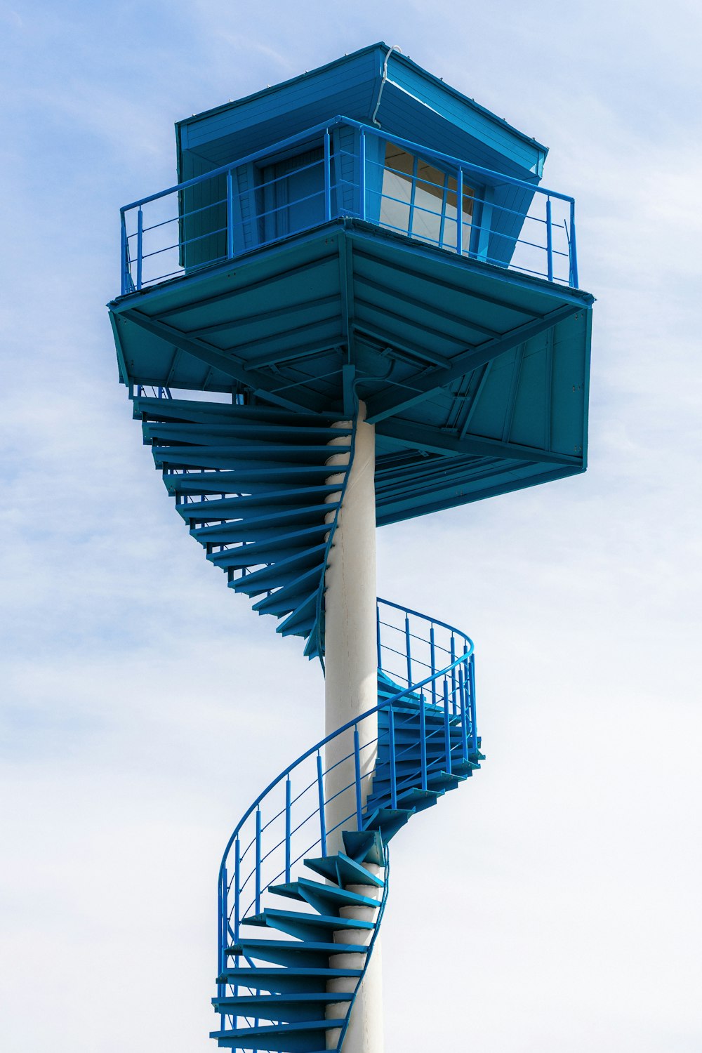 a tall blue tower with a spiral staircase