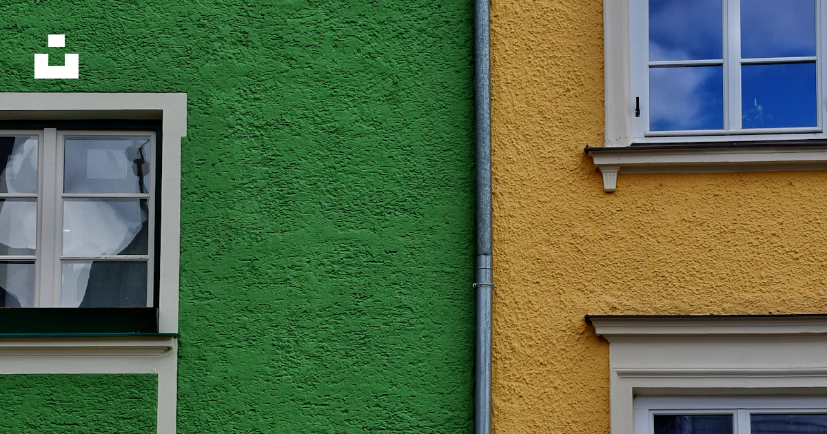 A green and yellow building next to a yellow and green building photo ...