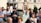 A group of happy clients standing in front of their completed building.