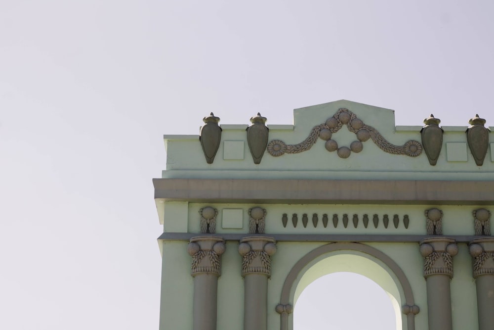 a large white clock tower with a sky background