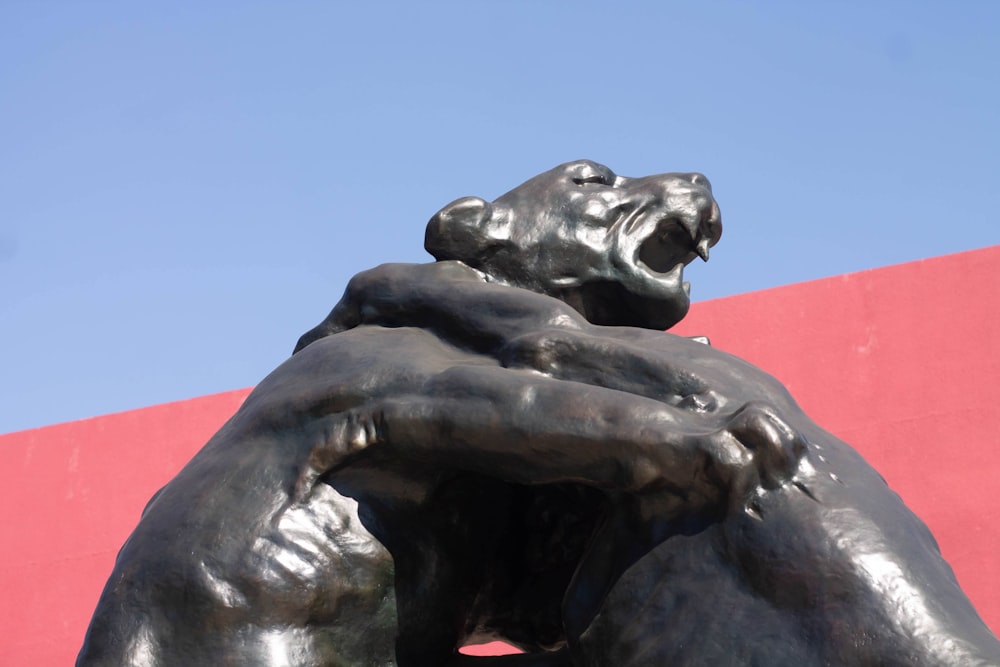 a statue of a bear holding another bear