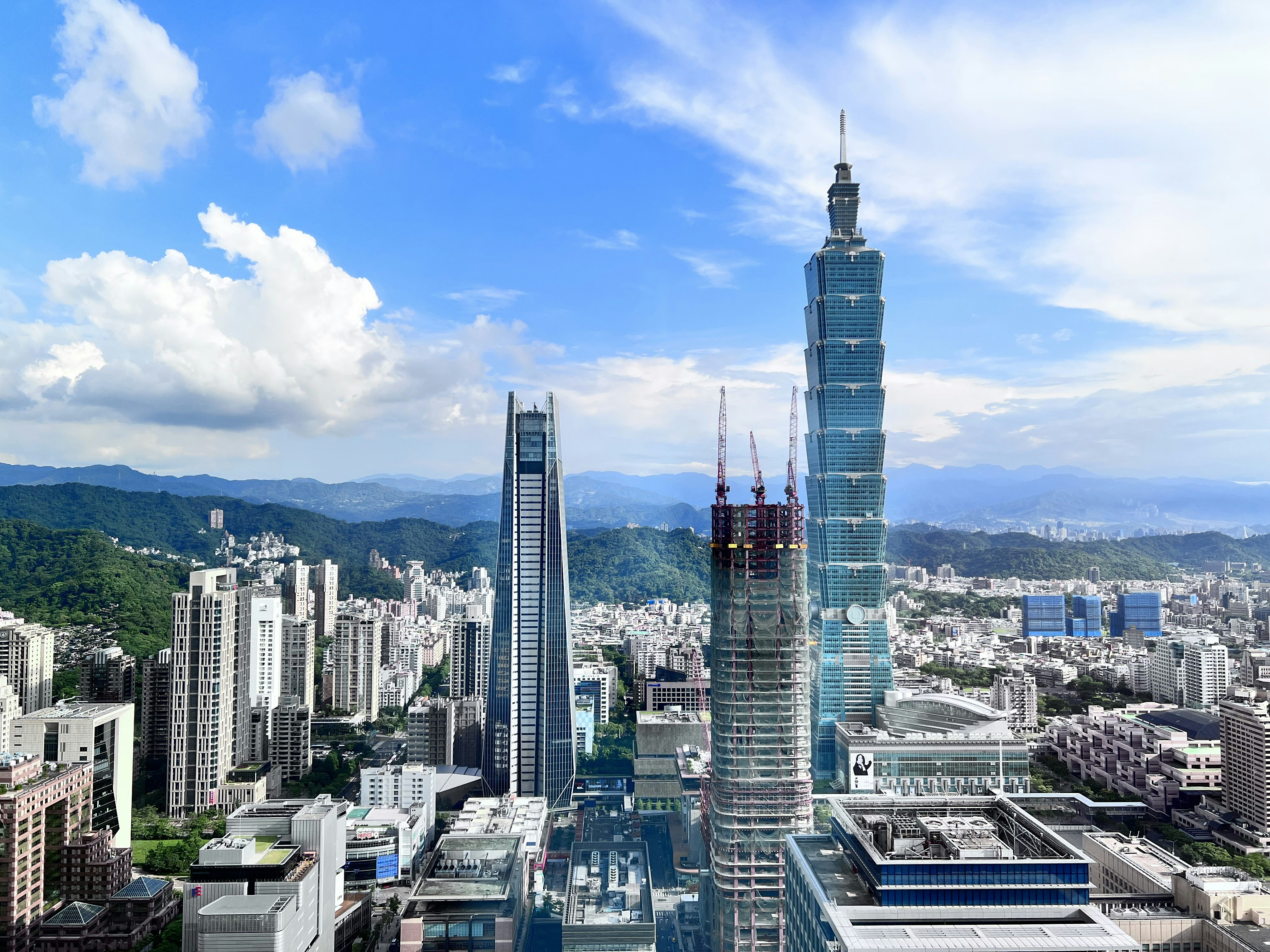 a view of a city with skyscrapers and mountains in the background