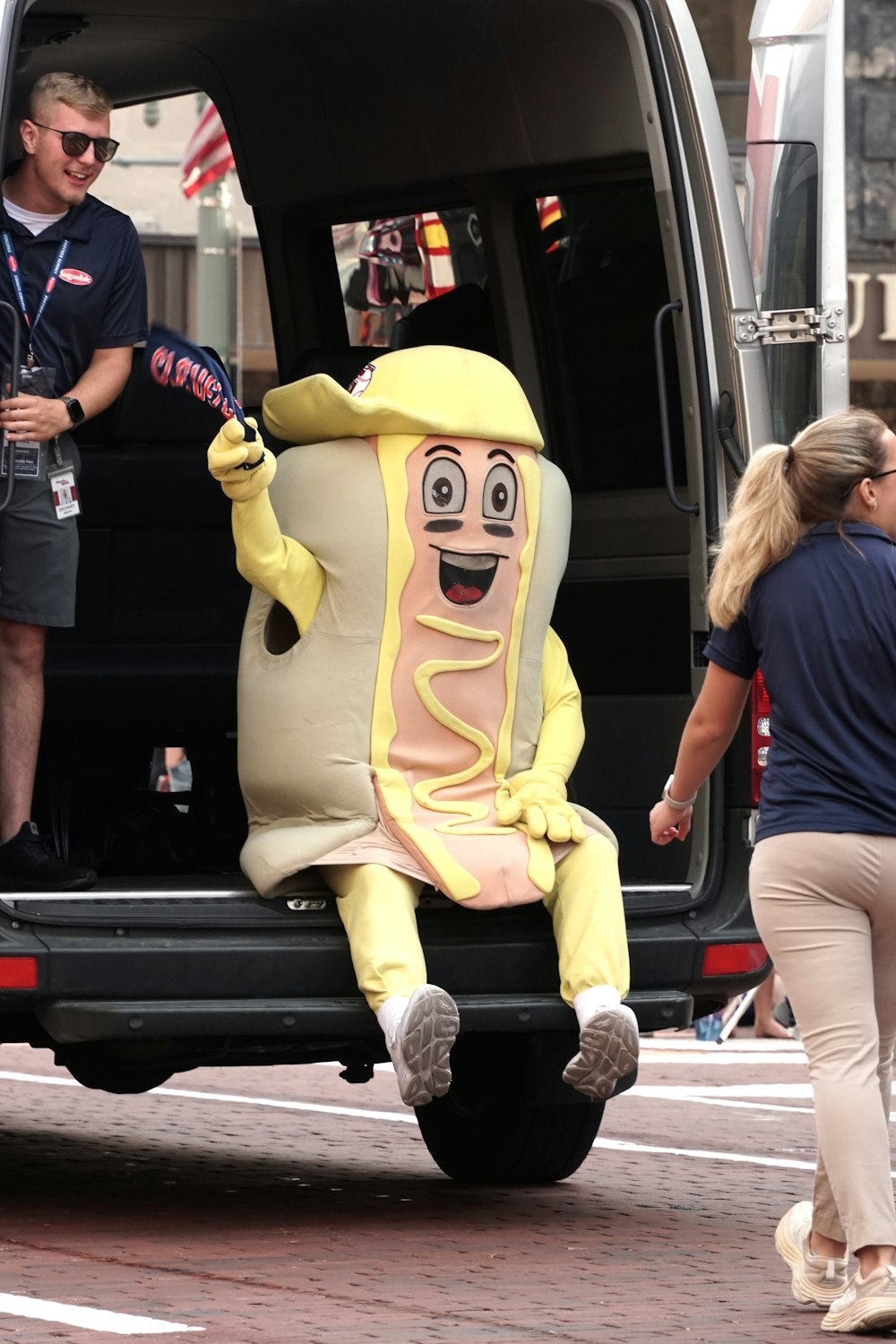 a giant hot dog sitting in the back of a van