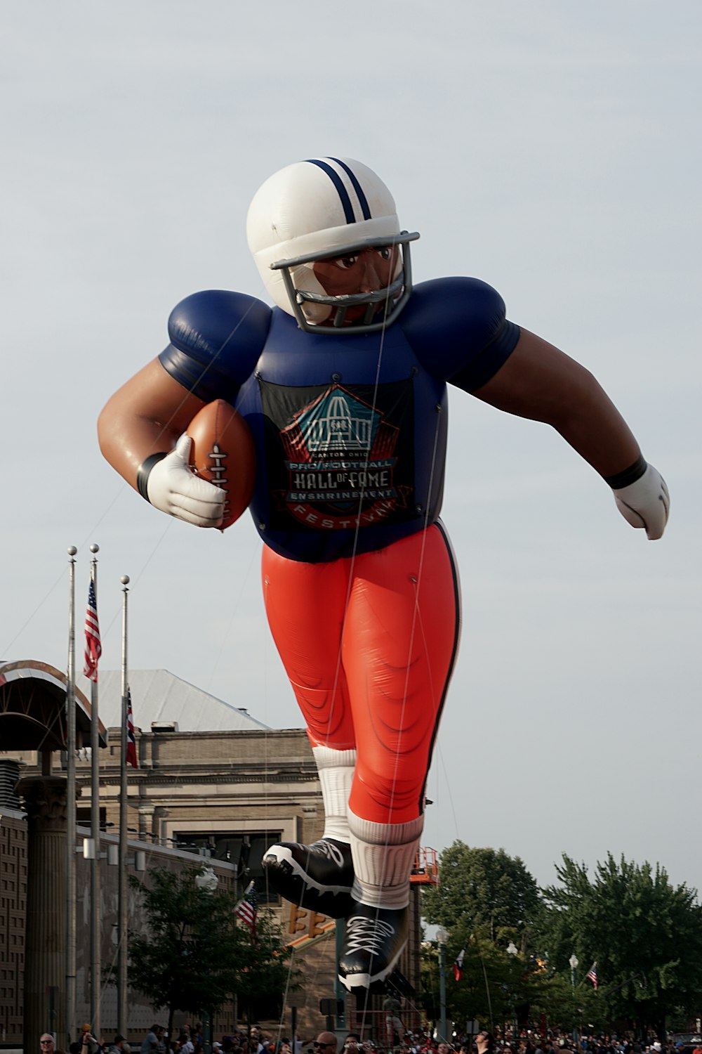 a large inflatable football player is in the air