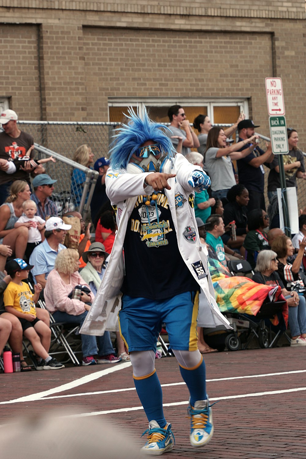 a man with blue hair walking down a street