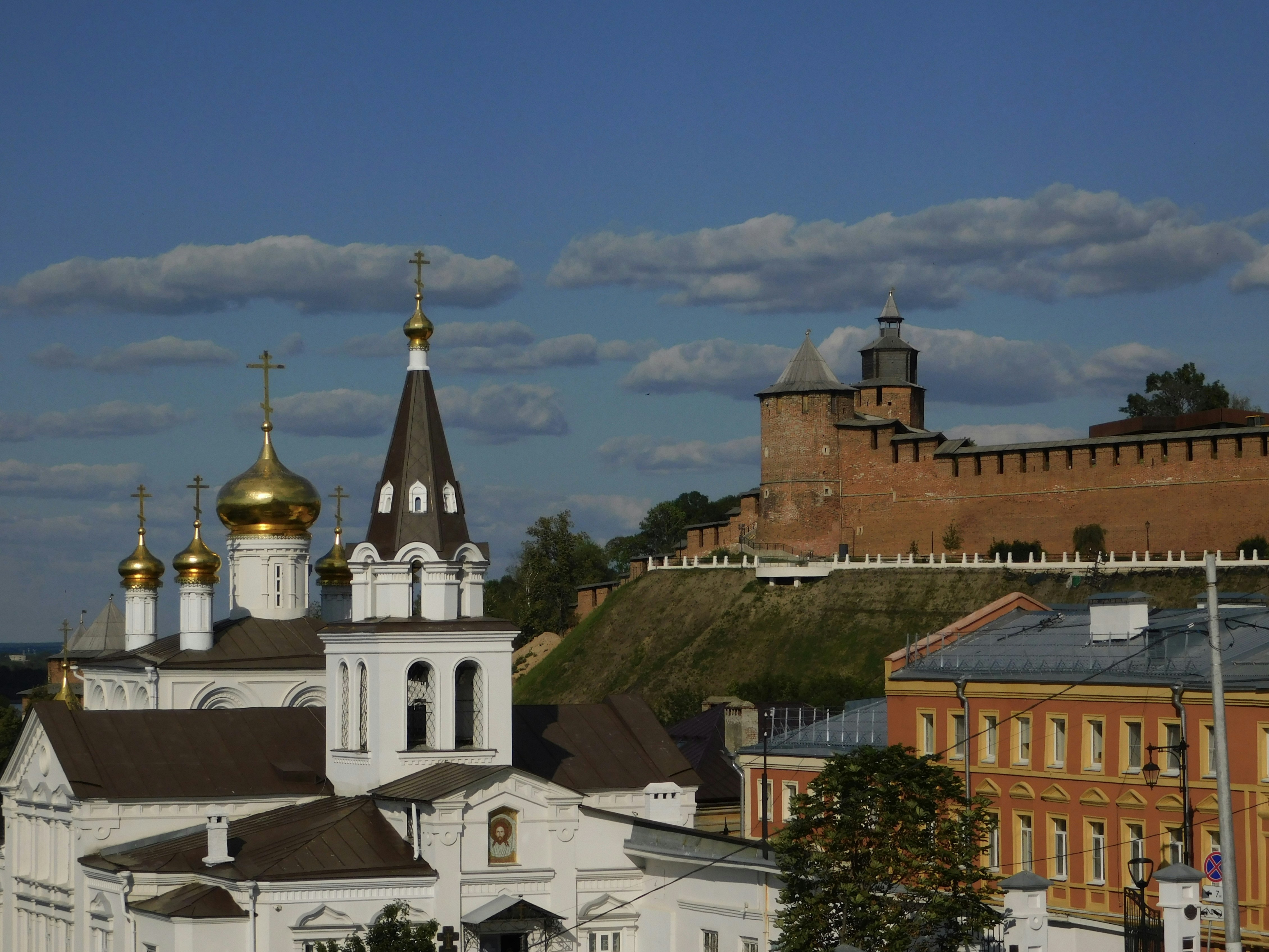 a large white building with gold domes on top of it