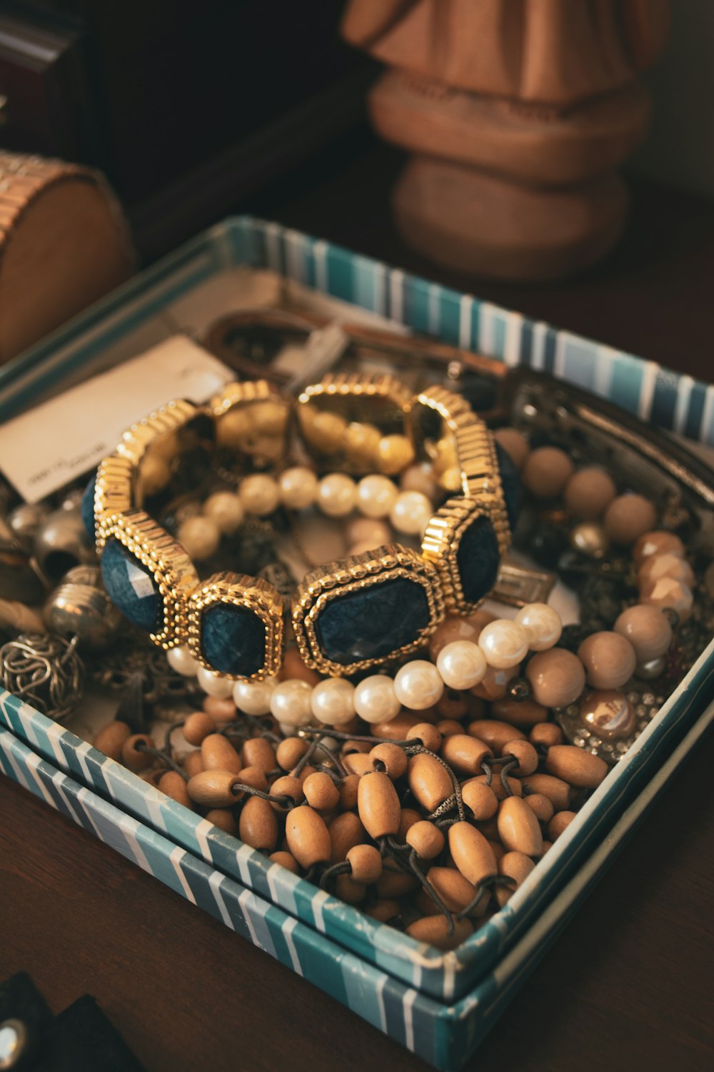 a box filled with lots of jewelry on top of a table