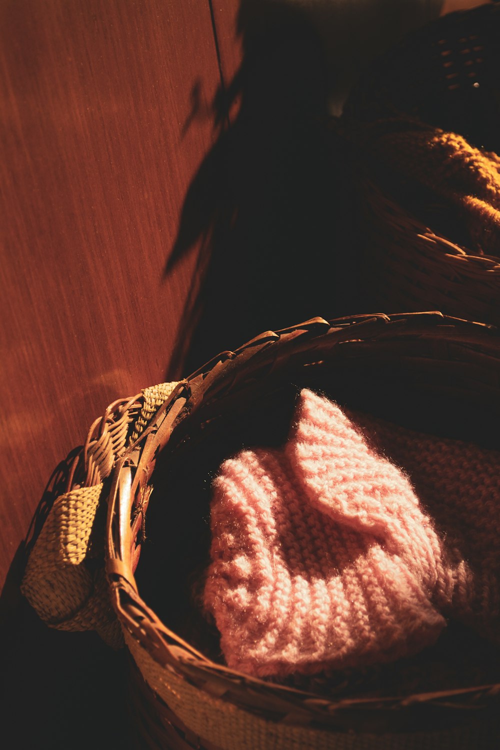 a knitted hat in a basket on a table