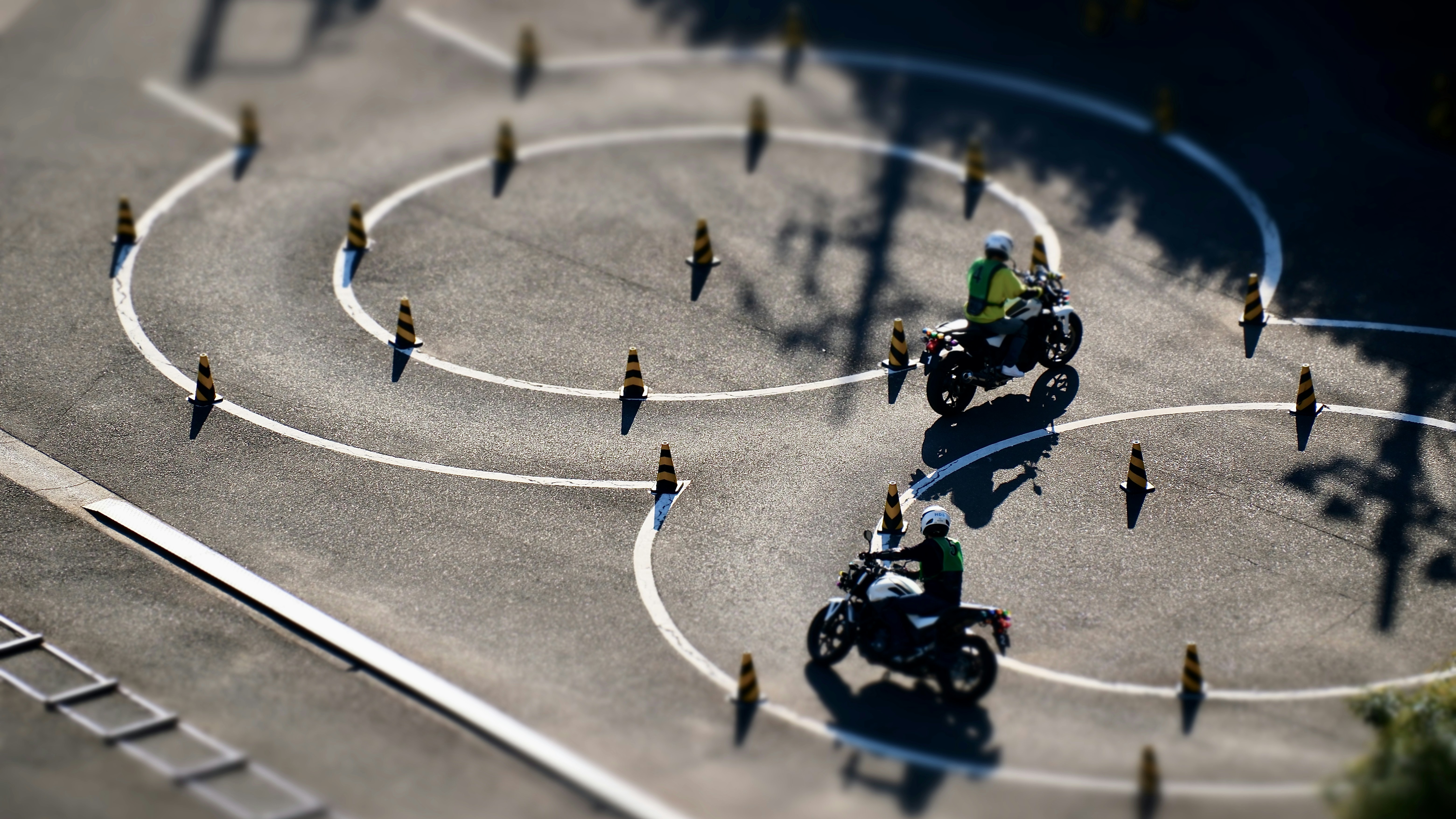 a group of people riding motorcycles around a circle