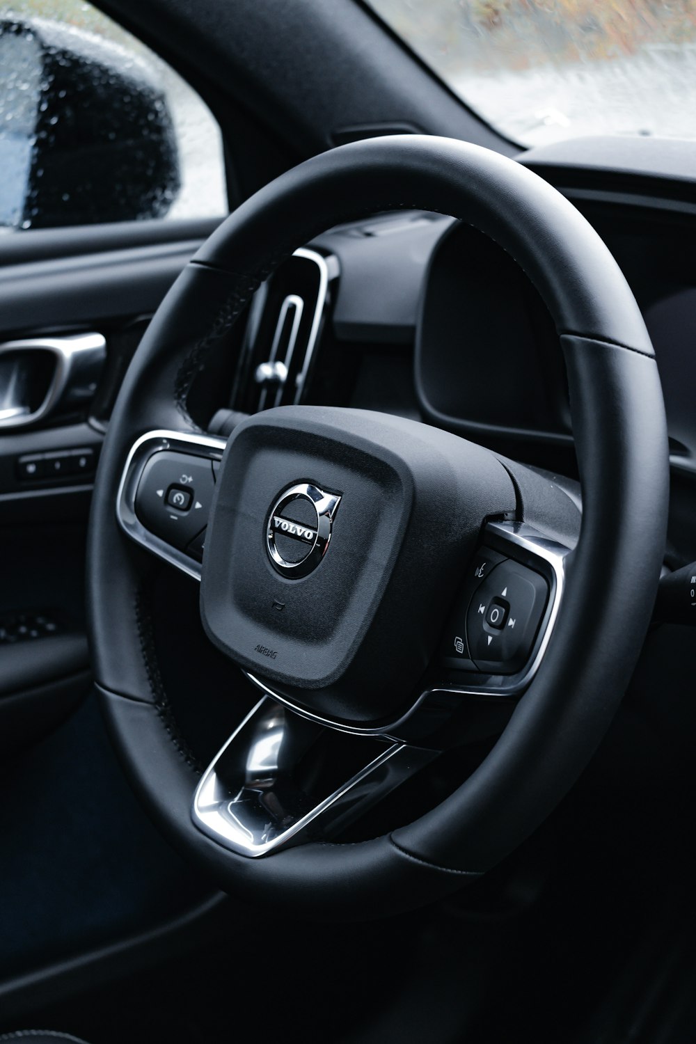 the steering wheel of a car with a black dashboard