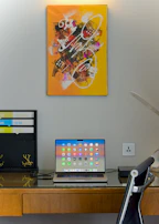 A vibrant workspace featuring a laptop displaying a productivity app.