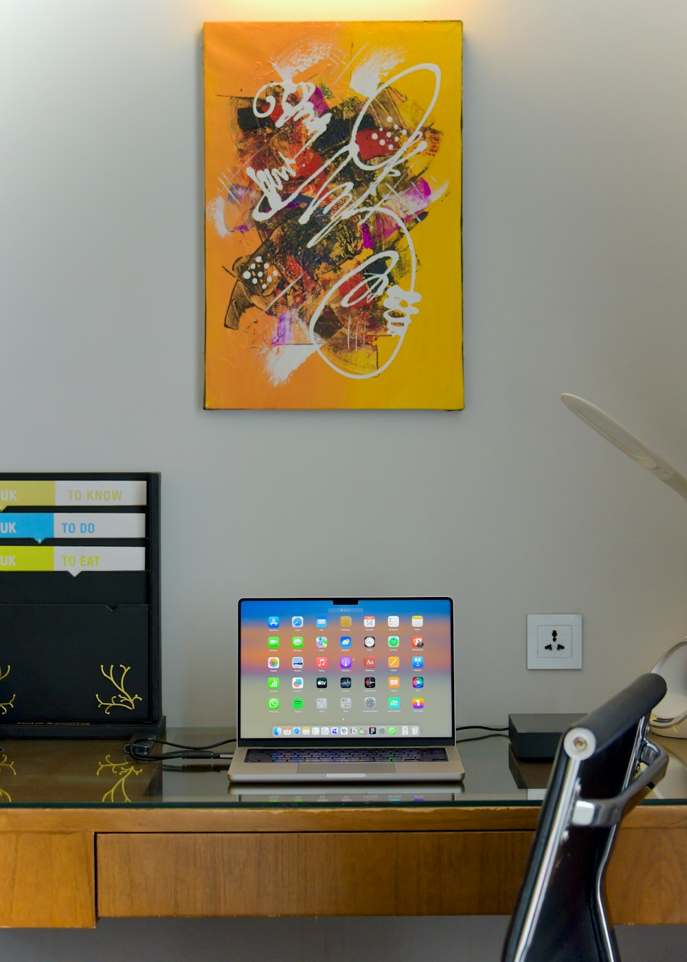 a laptop computer sitting on top of a wooden desk