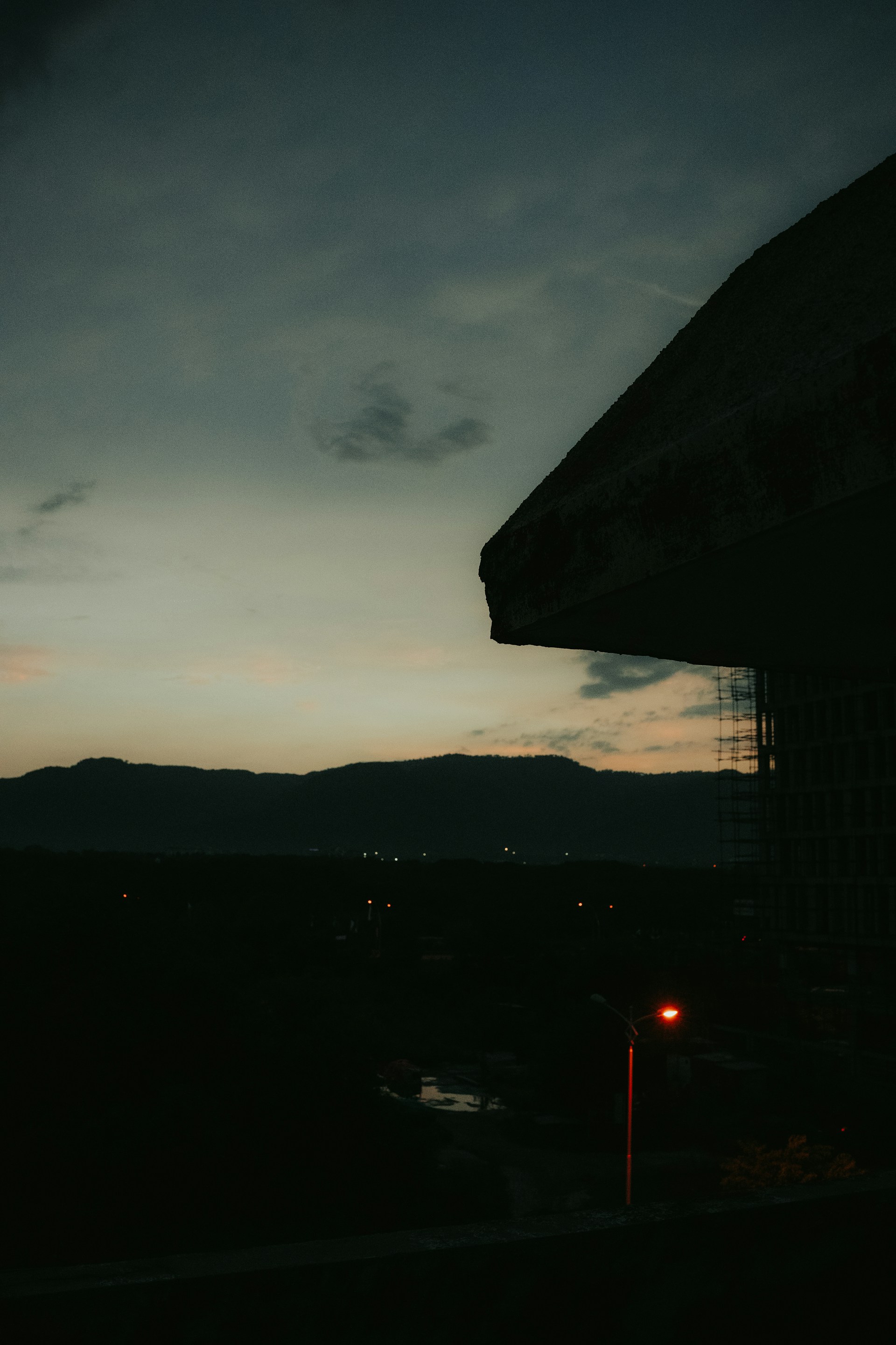 A moody still from keane austin's latest music video, casting soft shadows over a city skyline at dusk.