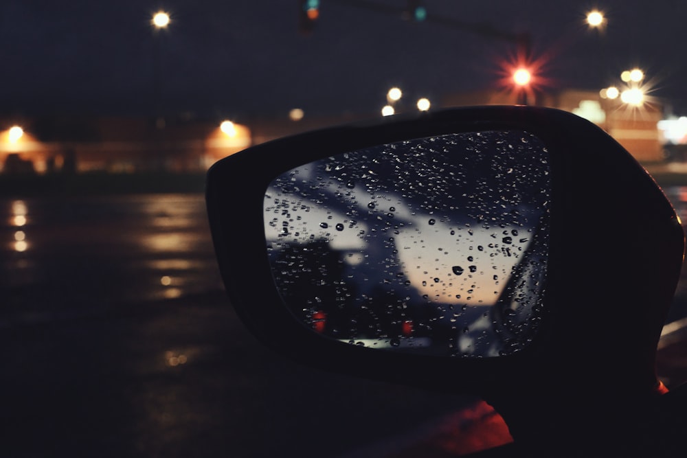 a rear view mirror with rain drops on it