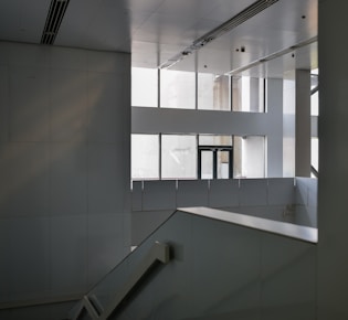 an empty building with a staircase and windows