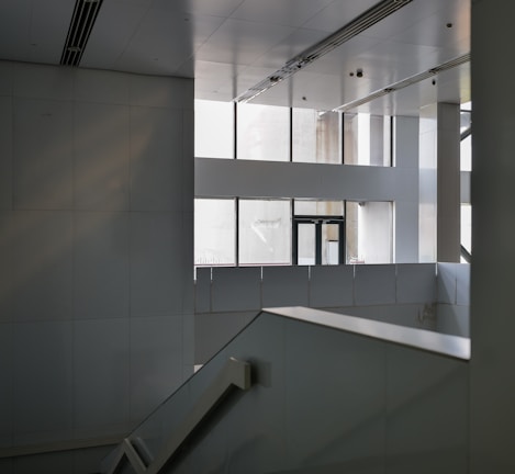 an empty building with a staircase and windows