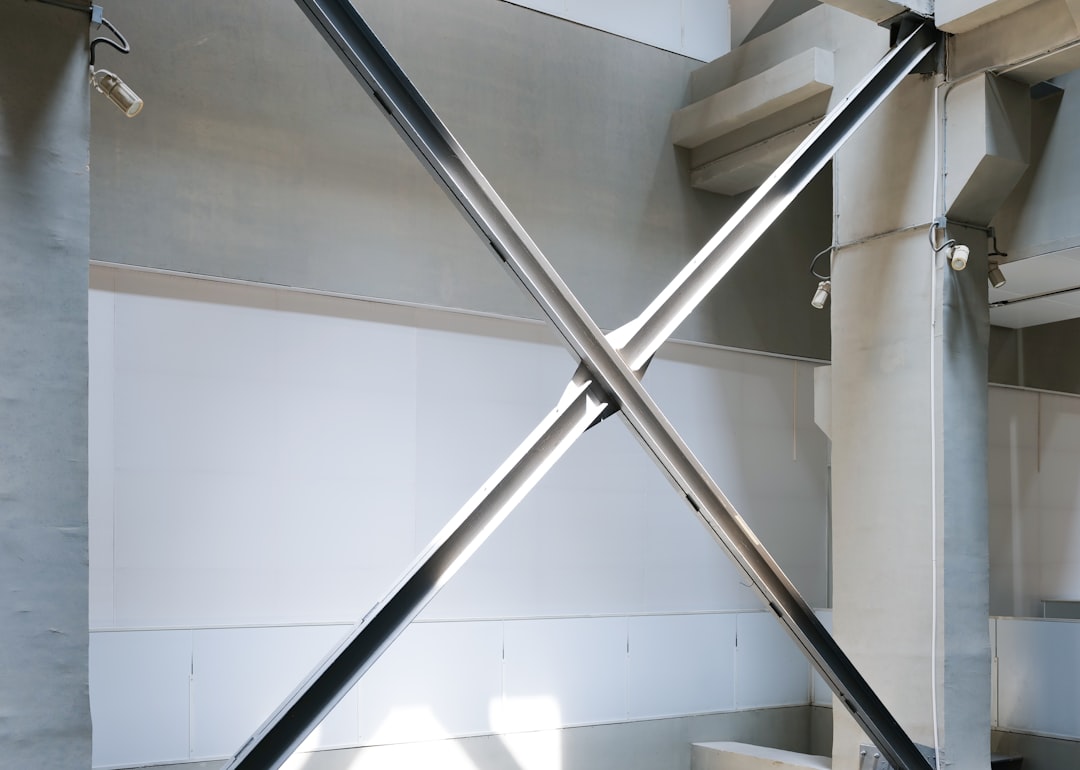 a metal object in a room with white walls, Steel and concrete structures