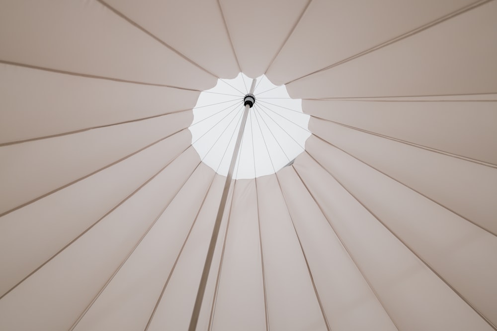 a close up of a white umbrella with a white background