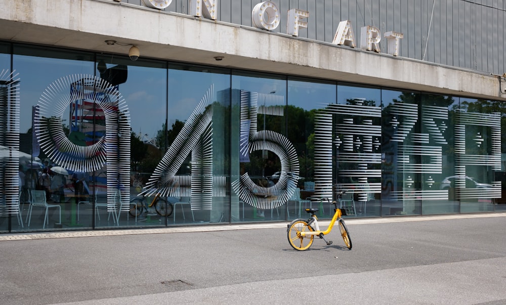 a yellow bike parked in front of a building