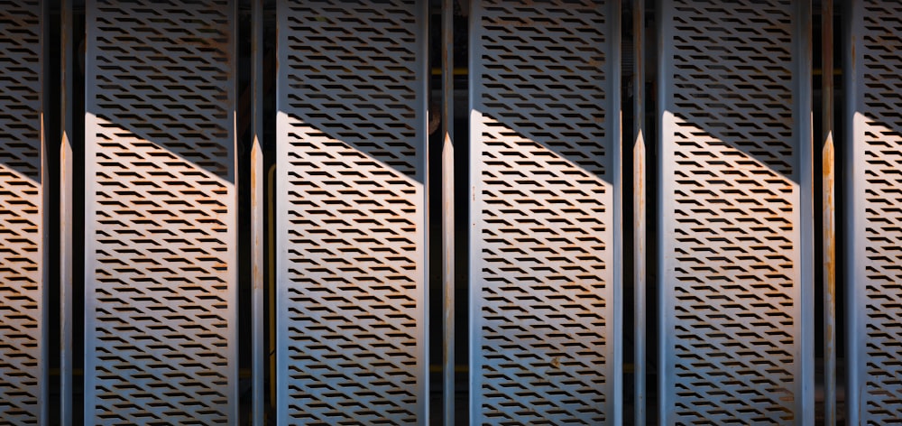 a row of metal grilles with a clock on each side