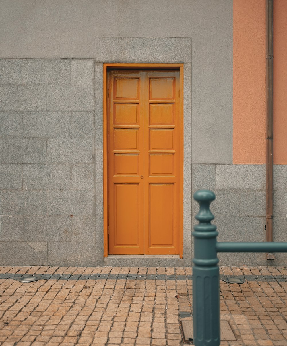 a yellow door is on a gray building