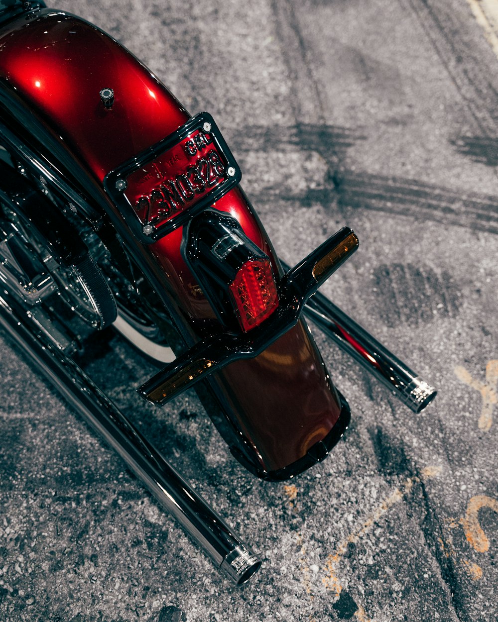 a red motorcycle parked on the side of the road