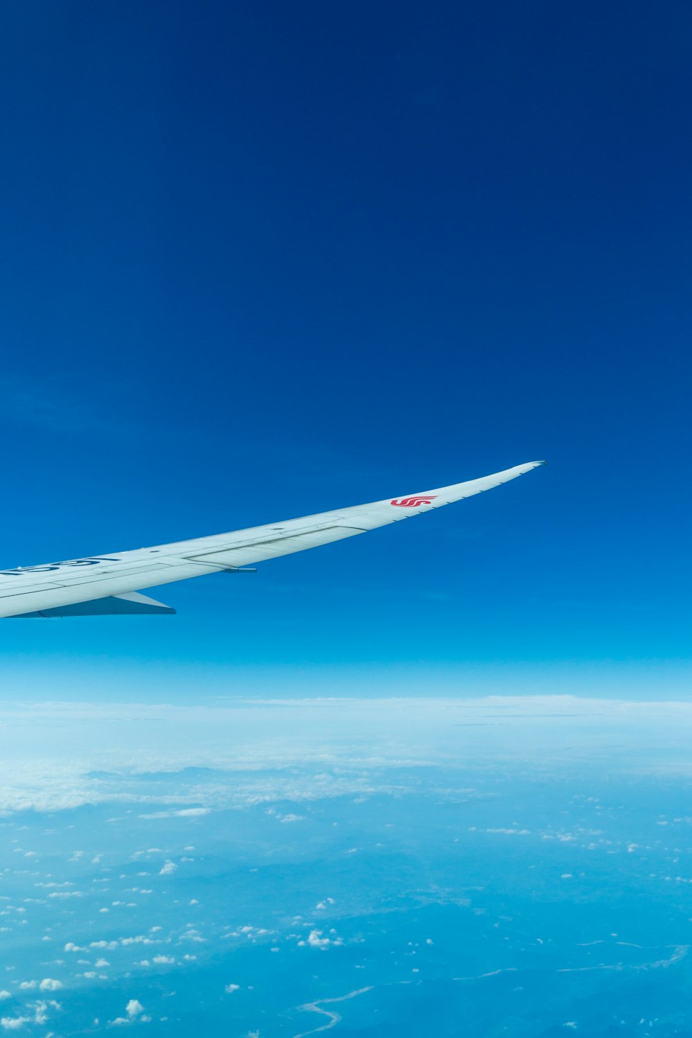 a view of the wing of an airplane in the sky