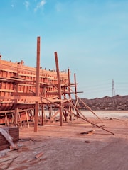 A sturdy wooden structure being built on a construction site.