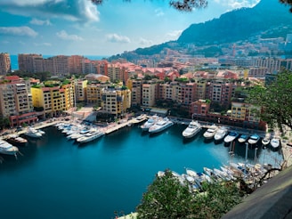 A bright sunny marina in Mallorca with boats docked against the backdrop of the island’s coastline.