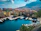 A vibrant marina in Split filled with colorful yachts under a clear blue sky.