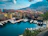 A vibrant marina in Split filled with colorful yachts under a clear blue sky.