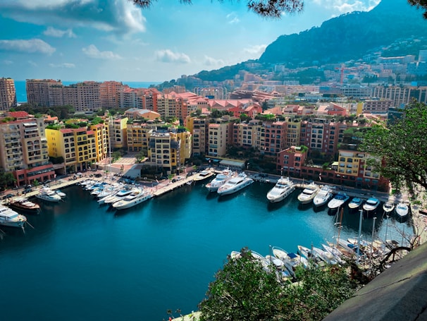 A bright sunny marina in Mallorca with boats docked against the backdrop of the island’s coastline.