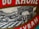 A close-up of a label featuring a detailed illustration of a vineyard hillside with several small buildings. The label includes bold red text with serif fonts.