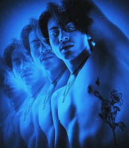 Multiple overlayed images of a shirtless person with a tattoo of flowers on the shoulder. The person wears a necklace and has a calm or introspective expression. The artwork is heavily saturated in blue tones, giving it a surreal and dreamy effect.