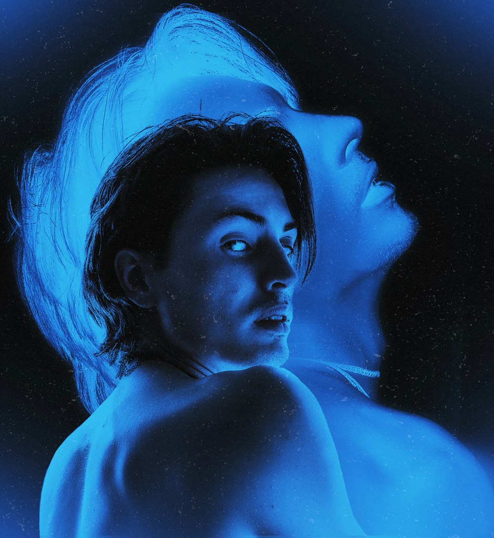 a man and a woman in blue light
