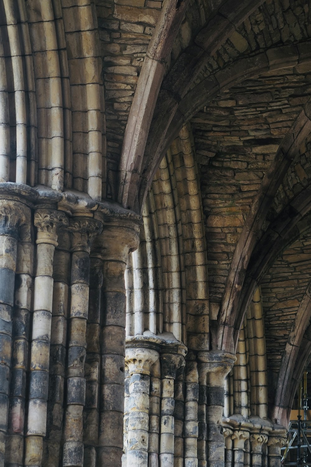 a large stone building with a clock on it's side