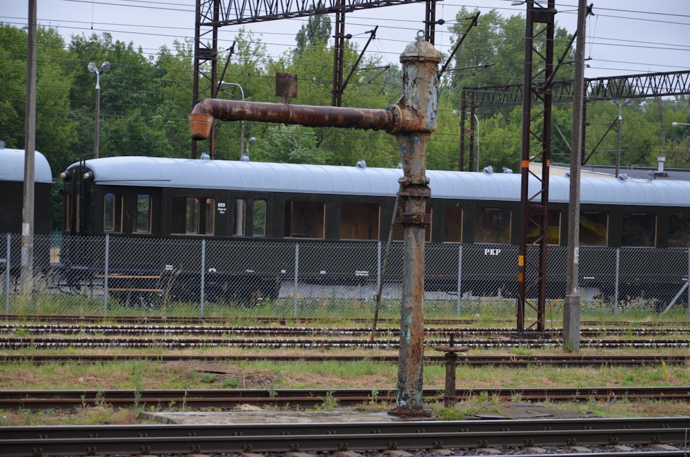 a train on a train track near a fence