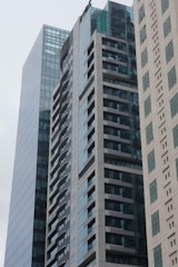 Modern residential and commercial buildings developed by Sewu Development in a clean urban setting.