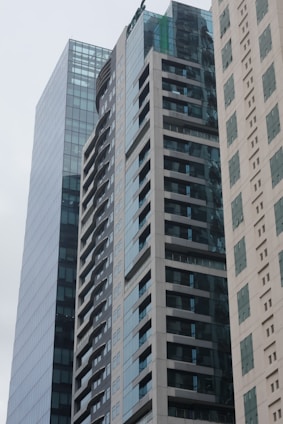 Modern residential and commercial buildings developed by Sewu Development in a clean urban setting.